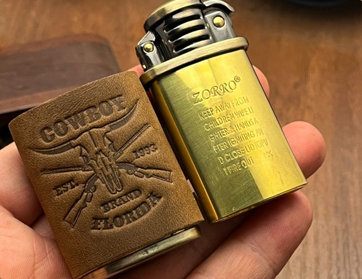 Handheld vintage brass oil lighter with brown leather wrap, refillable petrol lighter close-up