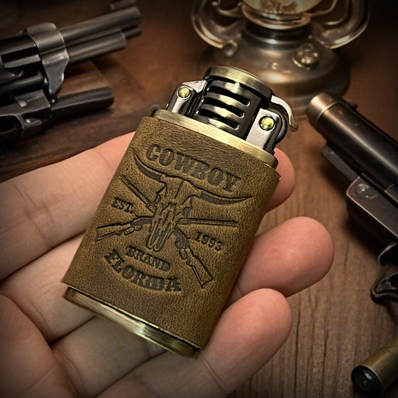 Handheld vintage brass oil lighter with brown leather wrap, refillable petrol lighter close-up