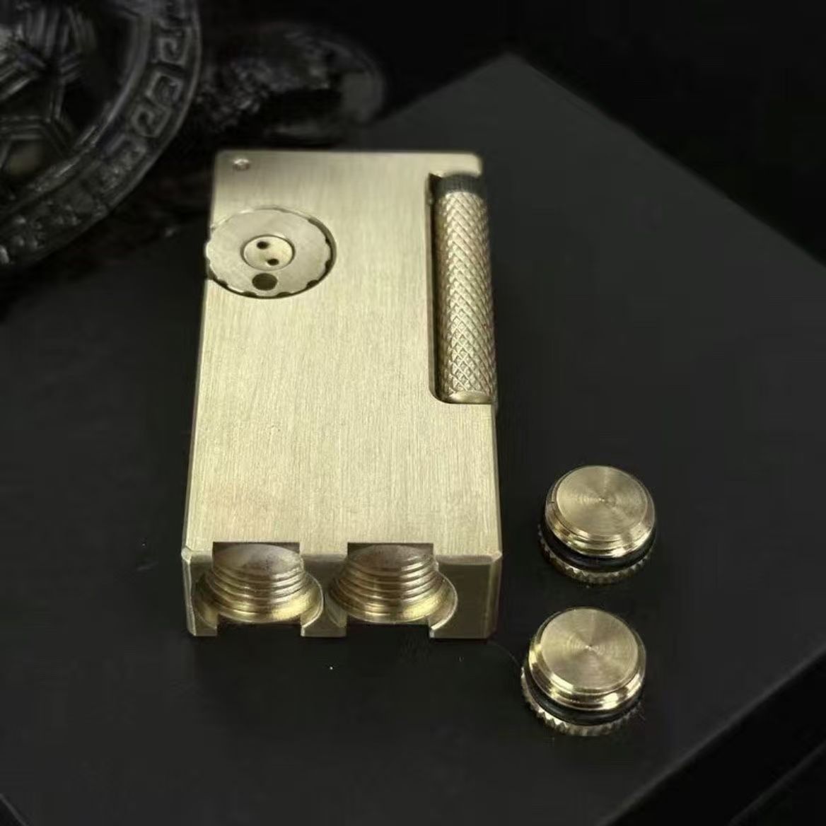 Vintage brass oil lighter with gold finish standing upright, refillable petrol lighter