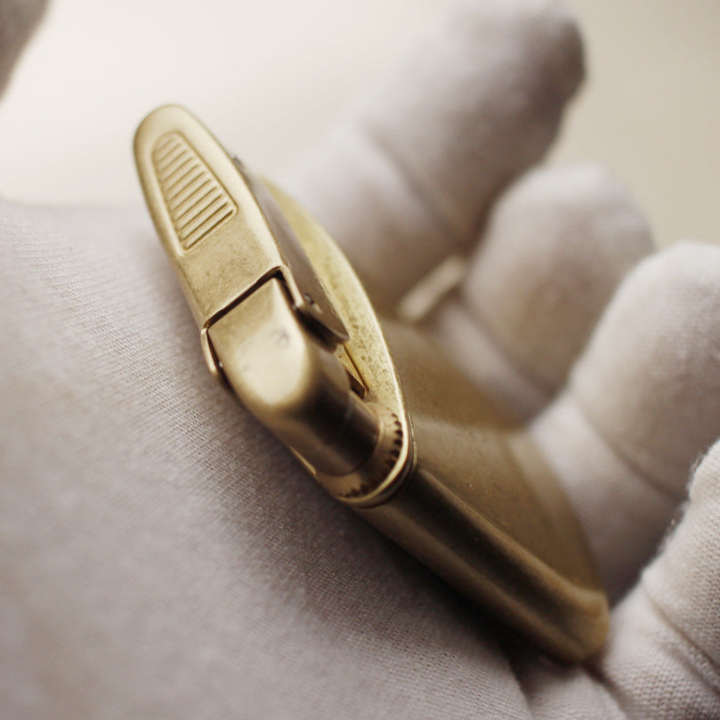 Vintage brass oil lighter with gold finish, refillable petrol lighter close-up