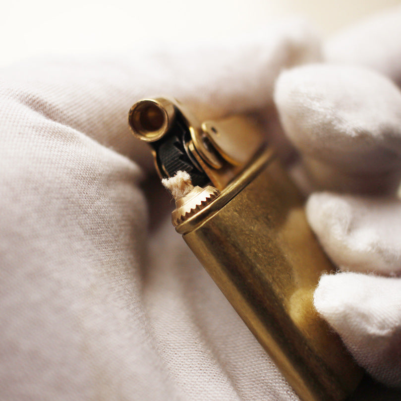 Vintage brass oil lighter with gold finish, refillable petrol lighter close-up