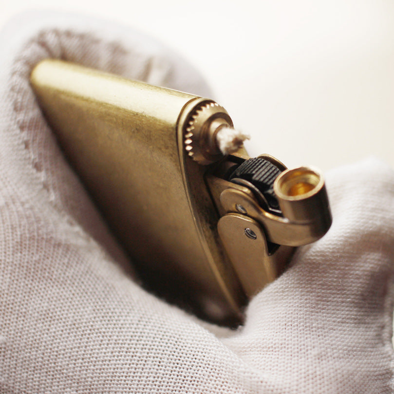 Vintage brass oil lighter with gold finish, refillable petrol lighter close-up