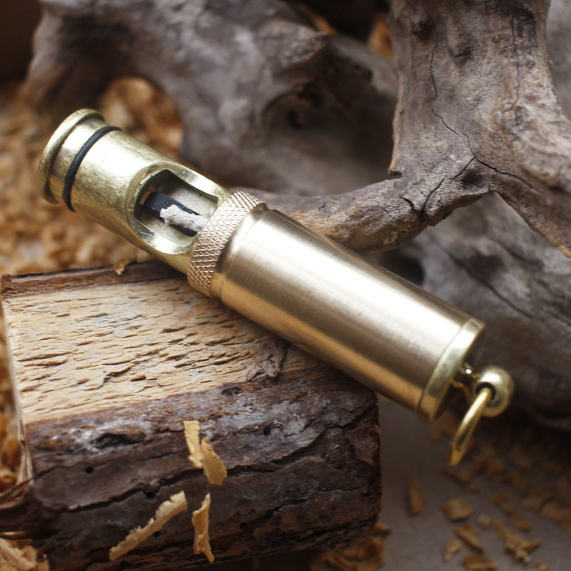 Handheld vintage brass oil lighter with visible wick, refillable petrol lighter close-up
