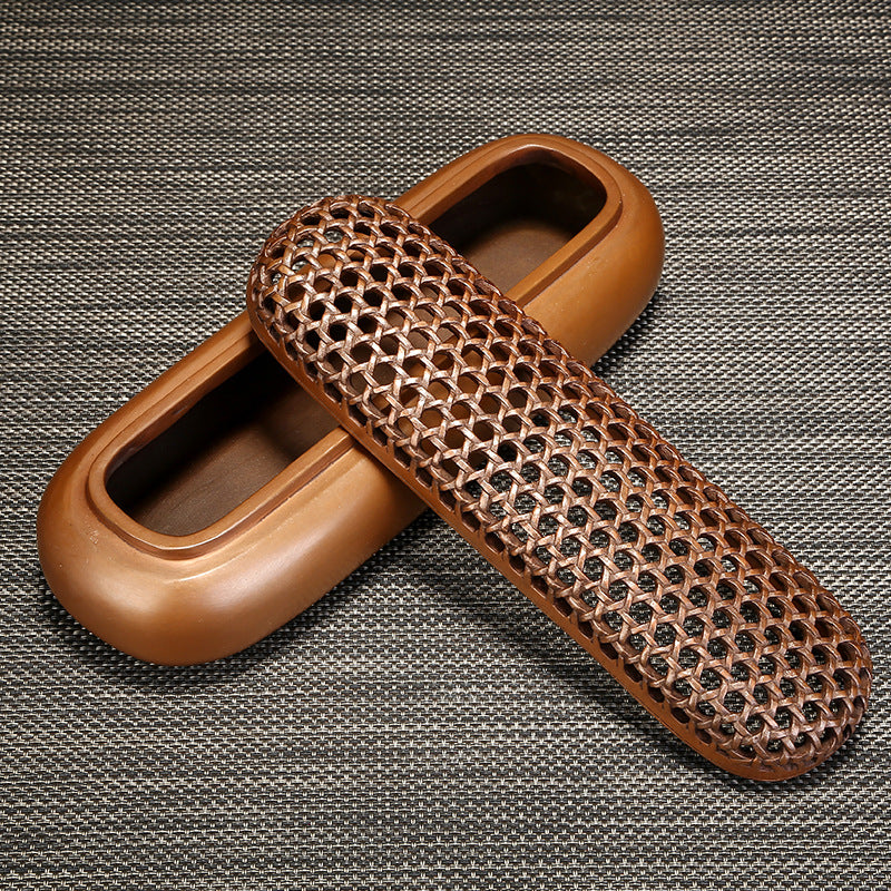 Brown leather shoe scrubber on a textured gray background