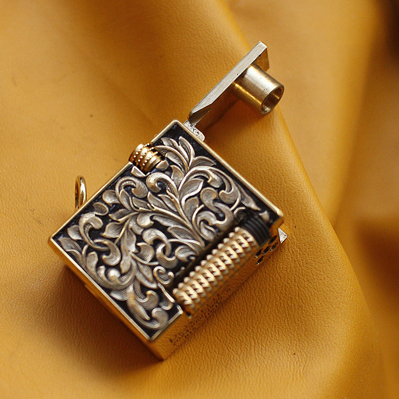 Vintage brass oil lighter keychain hanging, refillable petrol lighter close-up