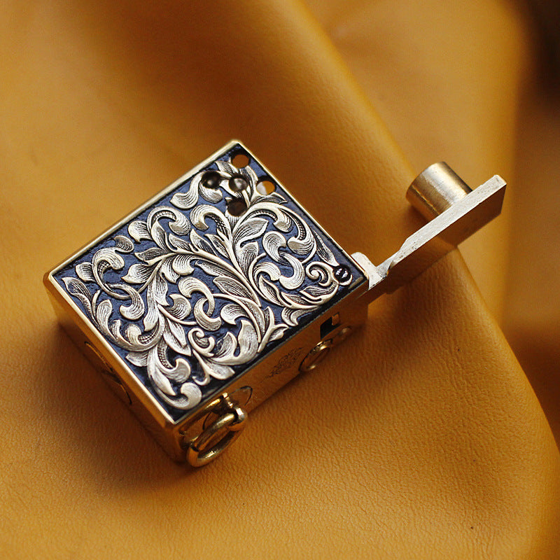 Vintage brass oil lighter keychain hanging, refillable petrol lighter close-up