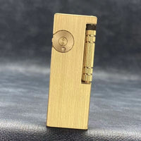 Vintage brass oil lighter with gold finish standing upright, refillable petrol lighter