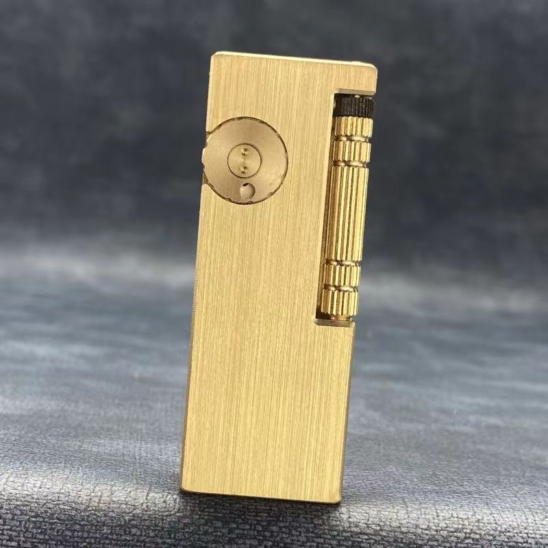 Vintage brass oil lighter with gold finish standing upright, refillable petrol lighter