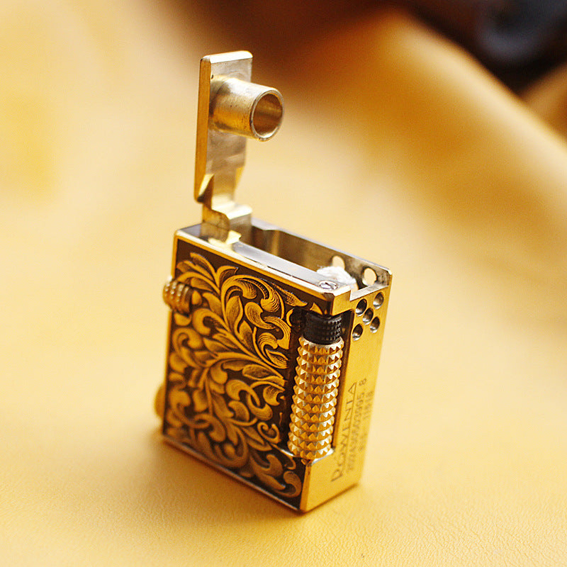 Vintage brass oil lighter keychain hanging, refillable petrol lighter close-up