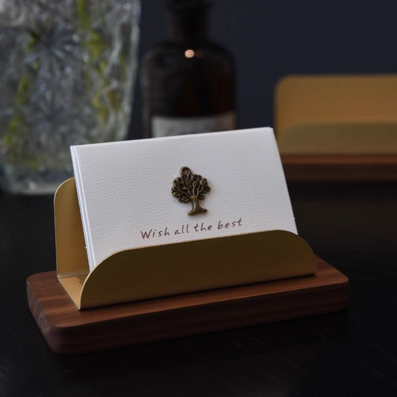 Walnut and brass business card holder on executive office desk