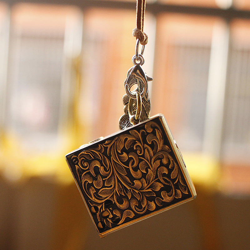 Vintage brass oil lighter keychain hanging, refillable petrol lighter close-up