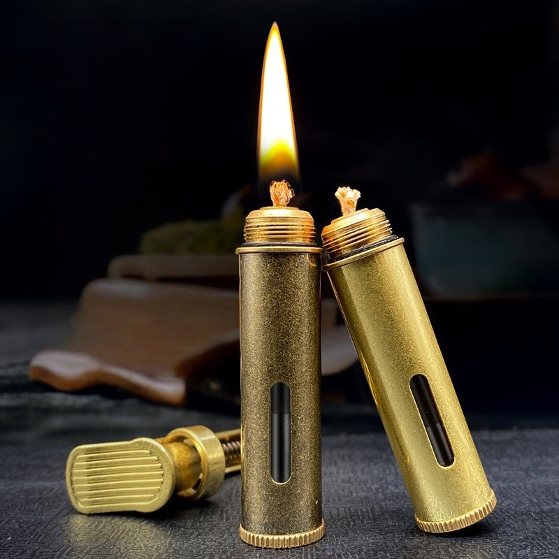 Handheld vintage brass oil lighter ignited with flame, refillable petrol lighter close-up
