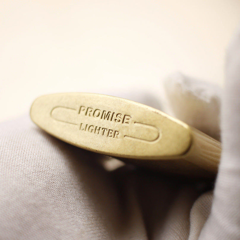 Vintage brass oil lighter with gold finish, refillable petrol lighter close-up