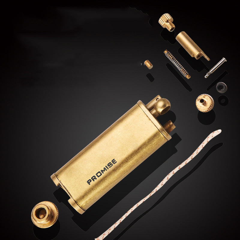 Vintage brass oil lighter ignited with flame and sparks, refillable petrol lighter close-up