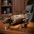 Solid brass bull sculpture displayed on a wooden desk in a private study.