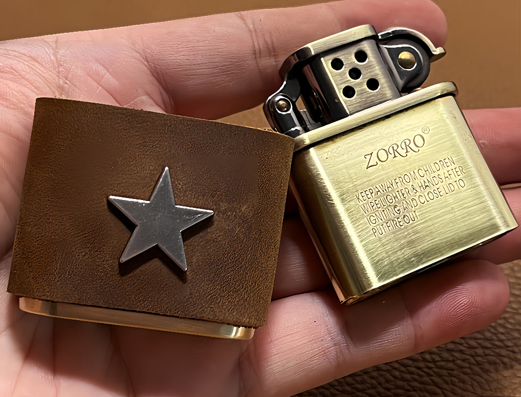 Handmade brown leather wrapped brass oil lighter held in hand, vintage star design