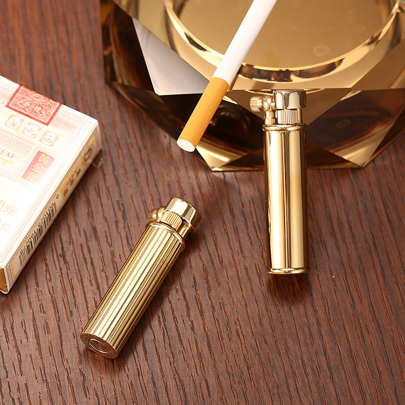 Vintage brass oil lighter with ribbed design standing upright, refillable petrol lighter
