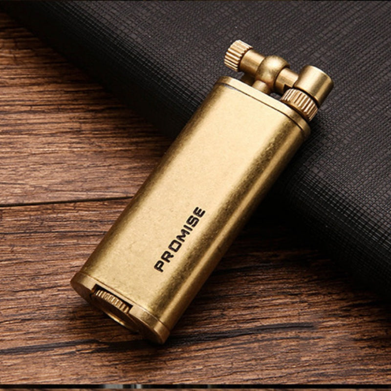 Vintage brass oil lighter ignited with flame and sparks, refillable petrol lighter close-up