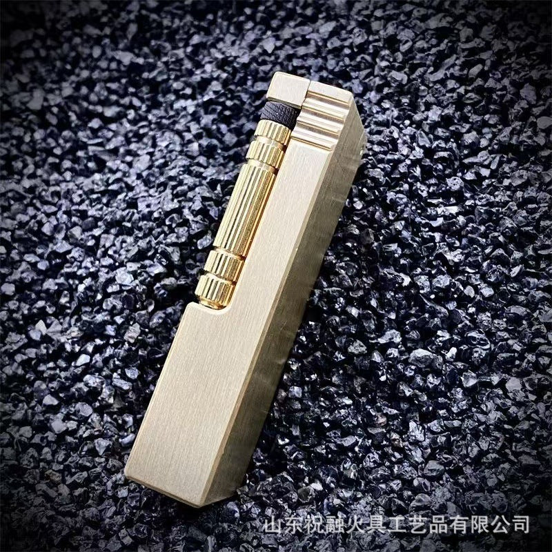 Vintage brass oil lighter with gold finish standing upright, refillable petrol lighter