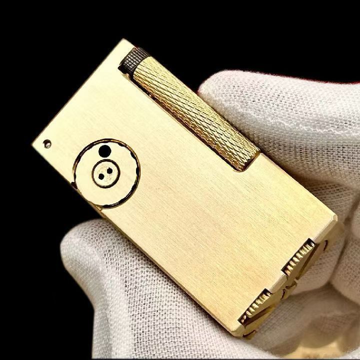 Vintage brass oil lighter with gold finish standing upright, refillable petrol lighter