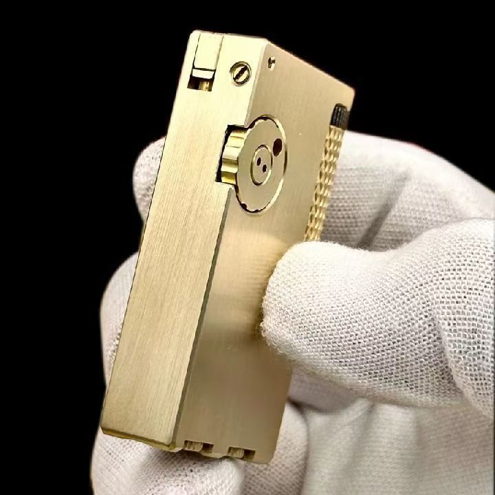 Vintage brass oil lighter with gold finish standing upright, refillable petrol lighter