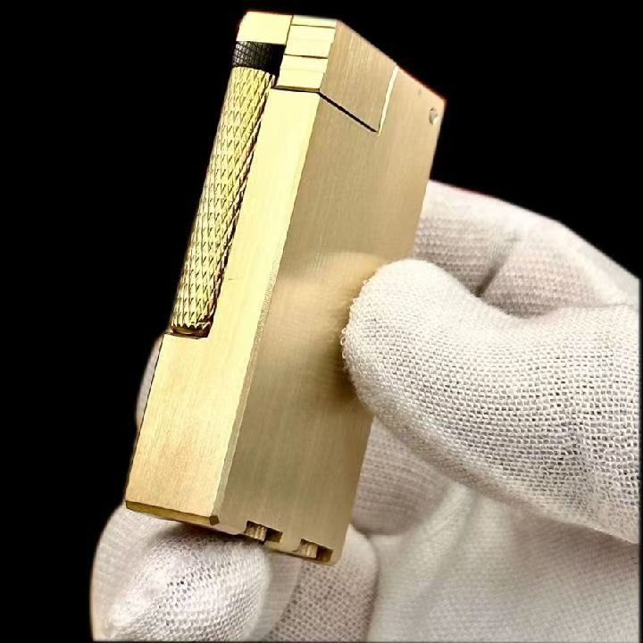 Vintage brass oil lighter with gold finish standing upright, refillable petrol lighter