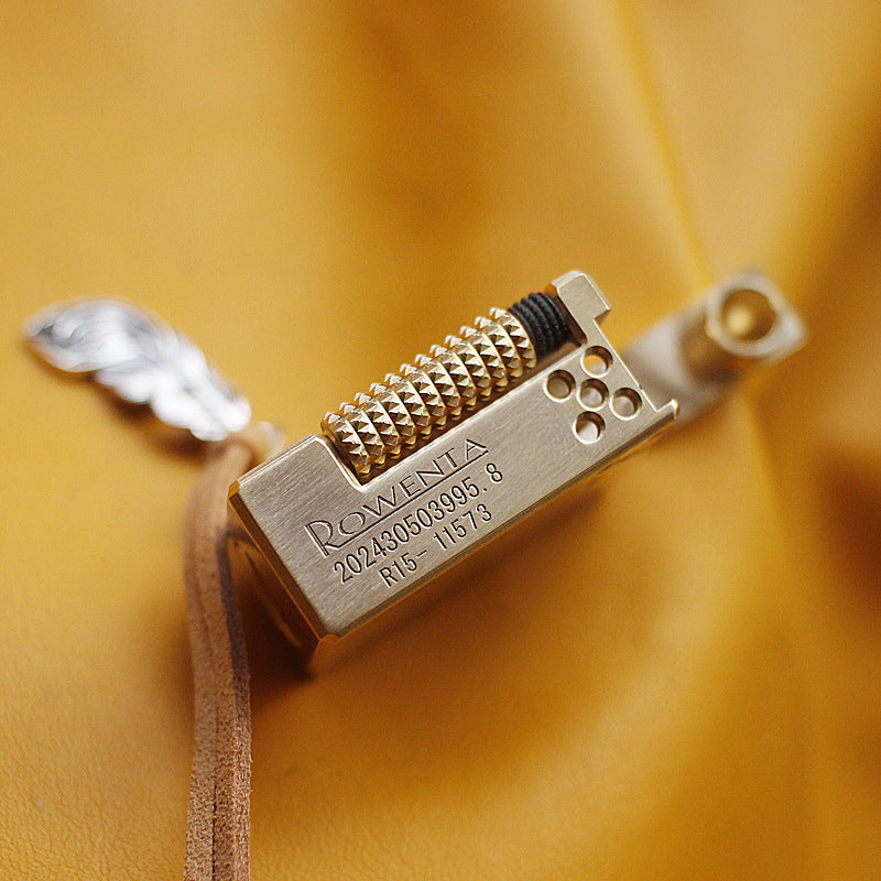 Vintage brass oil lighter keychain hanging, refillable petrol lighter close-up