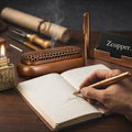 A quiet private study scene with brass writing instruments, an oil lighter, and a notebook on a wooden desk.