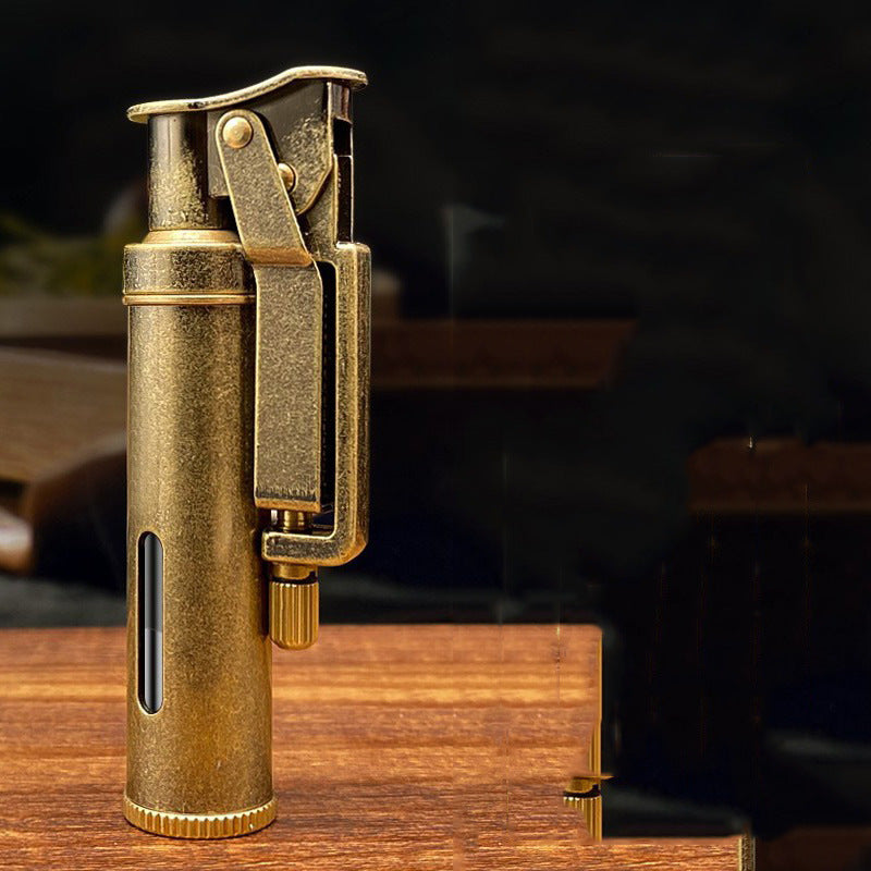Handheld vintage brass oil lighter ignited with flame, refillable petrol lighter close-up
