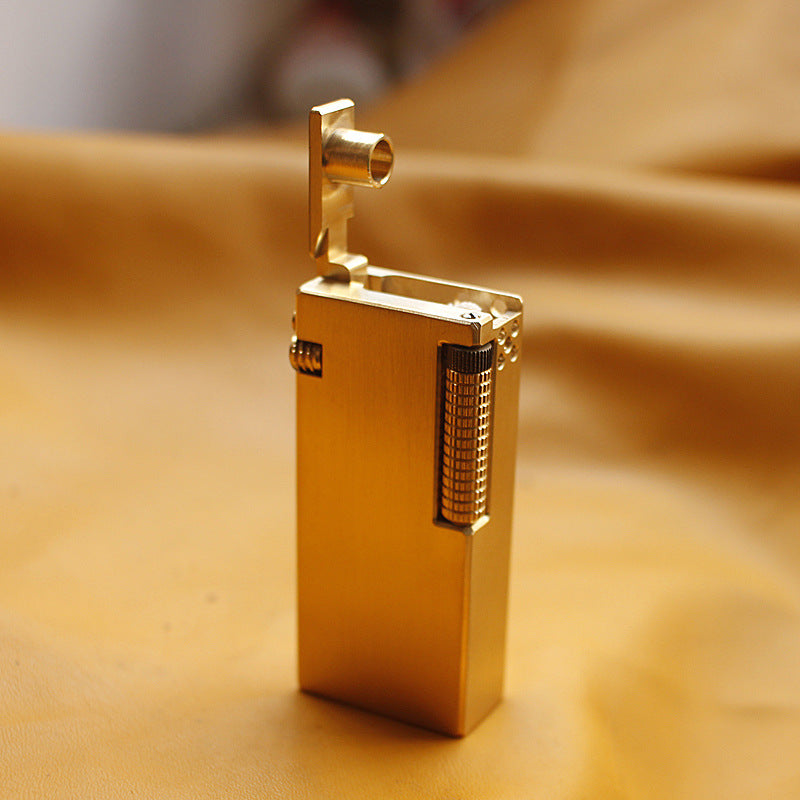 Vintage brass oil lighter with gold finish standing upright, refillable petrol lighter
