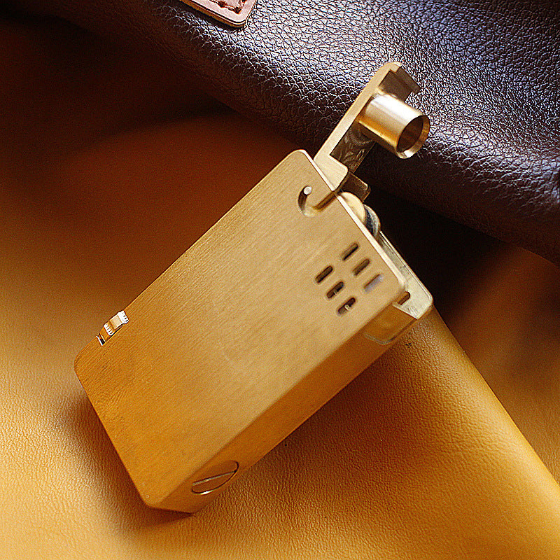 Vintage brass oil lighter with gold finish standing upright, refillable petrol lighter